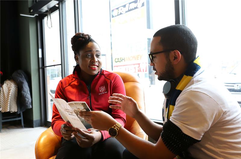 The Salvation Army representative discusses available programs with a community member.